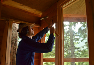 Installing the sliding glass pocket door. Behind me, A cove window built around a neighboring tree.